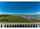 Water view from balcony overlooking lush vegetation at 1410 Beach Rd # 201, Englewood, FL 34223