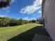 Grassy backyard with green foliage and beautiful landscaping at 14244 Spruce Ln, Port Charlotte, FL 33953