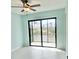 Light-filled room with a ceiling fan, tile floors, and sliding glass doors at 14261 Joggins Ave, Port Charlotte, FL 33981