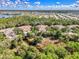 Scenic aerial view showcasing a neighborhood with mature trees, landscaping, and nearby waterways at 14298 Reserve Ct, Port Charlotte, FL 33953