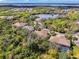 Gorgeous aerial view showcasing a neighborhood with mature trees and beautiful water views at 14298 Reserve Ct, Port Charlotte, FL 33953