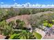 An aerial view showing the home's well-maintained terracotta-colored roof and lush tropical landscaping at 14298 Reserve Ct, Port Charlotte, FL 33953