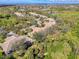 Scenic aerial view showcasing a neighborhood with mature trees, landscaping, and nearby waterways at 14298 Reserve Ct, Port Charlotte, FL 33953