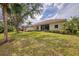 Expansive backyard featuring lush landscaping and a screened lanai for outdoor enjoyment at 14298 Reserve Ct, Port Charlotte, FL 33953
