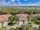 Charming aerial view of a lovely home featuring a three-car garage and a well manicured lawn at 14298 Reserve Ct, Port Charlotte, FL 33953