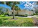 Beautiful single-Gathering home with lush landscaping, a well-maintained lawn, and an attached garage at 14298 Reserve Ct, Port Charlotte, FL 33953
