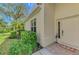 Inviting front entrance with a decorative door, tiled porch, and manicured landscaping at 14298 Reserve Ct, Port Charlotte, FL 33953