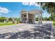 A brick guard house with a covered entrance and manicured landscaping at the entry to the property at 14298 Reserve Ct, Port Charlotte, FL 33953