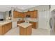 Bright and airy kitchen featuring wood cabinetry and stainless steel appliances at 14298 Reserve Ct, Port Charlotte, FL 33953