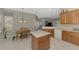 Bright kitchen with tiled floors, a functional island, and dining space at 14298 Reserve Ct, Port Charlotte, FL 33953