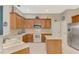 Open concept kitchen with wood cabinets, a tile backsplash, and stainless steel appliances at 14298 Reserve Ct, Port Charlotte, FL 33953