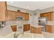 Spacious kitchen with wood cabinets, stainless steel refrigerator, and tile flooring at 14298 Reserve Ct, Port Charlotte, FL 33953