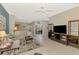 Living room showing tile floors, furniture, entertainment center and access to other rooms at 14298 Reserve Ct, Port Charlotte, FL 33953