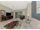 Comfortable living room featuring neutral colors, tile floors and sliding glass doors to outdoor area at 14298 Reserve Ct, Port Charlotte, FL 33953