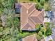 Aerial view featuring a well-maintained tile roof and lush landscaping surrounding the property at 14298 Reserve Ct, Port Charlotte, FL 33953