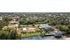 Aerial view showcasing home with waterfront access, private dock, boat, and outdoor entertaining at 14382 Lillian Cir, Port Charlotte, FL 33981
