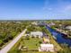 Home is settled on a freshwater canal with mature trees, boat dock, and screened-in lanai at 14382 Lillian Cir, Port Charlotte, FL 33981