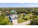 Aerial view of waterfront home with a private dock, lush backyard and covered patio at 14382 Lillian Cir, Port Charlotte, FL 33981