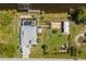 An aerial view showcasing the home's layout, pool, boat dock, and lush green surroundings at 14382 Lillian Cir, Port Charlotte, FL 33981