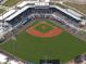 Aerial view of a baseball stadium packed with fans, showing the field, stands, and surrounding areas at 14382 Lillian Cir, Port Charlotte, FL 33981