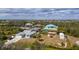 Aerial view showcases waterfront homes with boat docks on a canal system, surrounded by lush greenery at 14382 Lillian Cir, Port Charlotte, FL 33981