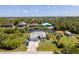 Aerial view of a waterfront home with a lush backyard and private dock at 14382 Lillian Cir, Port Charlotte, FL 33981