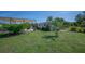 Well-maintained backyard featuring a covered patio area and a storage shed for outdoor convenience at 14382 Lillian Cir, Port Charlotte, FL 33981