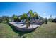 Spacious backyard with a screened lanai, comfortable lounge chairs, and tropical landscaping at 14382 Lillian Cir, Port Charlotte, FL 33981
