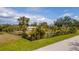 Fenced-in backyard with a shed, a pergola, and lush greenery at 14382 Lillian Cir, Port Charlotte, FL 33981