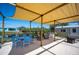 Shaded backyard patio with outdoor dining and lounge area, perfect for entertaining at 14382 Lillian Cir, Port Charlotte, FL 33981