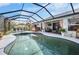 Spacious screened-in pool with hot tub, outdoor dining, and covered patio, perfect for entertaining at 14382 Lillian Cir, Port Charlotte, FL 33981