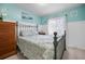 Comfortable bedroom with carpet, soothing color scheme, and a decorative wrought-iron bed frame at 14382 Lillian Cir, Port Charlotte, FL 33981