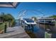 A private boat dock with a boat lift provides convenient access to waterways for boating and water activities at 14382 Lillian Cir, Port Charlotte, FL 33981
