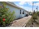 Charming exterior of home with well-maintained landscaping and a paved walkway at 14382 Lillian Cir, Port Charlotte, FL 33981