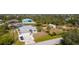Waterfront home featuring mature trees and a large yard with a boat lift and pool with cabana at 14382 Lillian Cir, Port Charlotte, FL 33981
