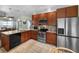 Updated kitchen features stainless steel appliances, granite countertops, wood cabinets, and a tile backsplash at 14382 Lillian Cir, Port Charlotte, FL 33981