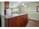 The kitchen features a granite countertop island with wood cabinets and a stainless steel sink at 14382 Lillian Cir, Port Charlotte, FL 33981