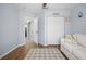 Well-lit living area with wood floors, offering a welcoming space with a glimpse into adjoining rooms at 14382 Lillian Cir, Port Charlotte, FL 33981
