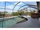 A sparkling pool inside screened enclosure with dining and a hot tub at 14382 Lillian Cir, Port Charlotte, FL 33981