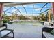 Screened-in pool area with plenty of space for entertaining and relaxation, creating a private outdoor oasis at 14382 Lillian Cir, Port Charlotte, FL 33981