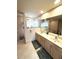 Bright bathroom featuring double vanity, glass shower, and large mirror at 14399 Morristown Ave, Port Charlotte, FL 33981