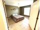 Cozy bedroom with a ceiling fan, large window, and earth tone wall color at 14399 Morristown Ave, Port Charlotte, FL 33981