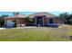 Charming single-story home featuring a well-manicured lawn and a screened front entry at 14399 Morristown Ave, Port Charlotte, FL 33981