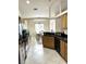 Kitchen view leading to the dining room with a view to the backyard at 14399 Morristown Ave, Port Charlotte, FL 33981