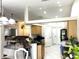 Bright kitchen features wooden cabinets, black countertops, and a breakfast bar overlooking the living area at 14399 Morristown Ave, Port Charlotte, FL 33981