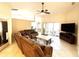 Open-concept living room boasts a large sectional sofa, ceiling fan, and sliding glass doors to the lanai at 14399 Morristown Ave, Port Charlotte, FL 33981
