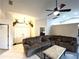 Inviting living room featuring a comfortable sectional sofa, ceiling fan, and unique deer head decor at 14399 Morristown Ave, Port Charlotte, FL 33981