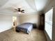 Spacious main bedroom with a tray ceiling, ceiling fan, and a view into the ensuite bathroom at 14399 Morristown Ave, Port Charlotte, FL 33981