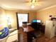 Home office featuring a large desk, comfortable seating, and ample natural light from the window at 14399 Morristown Ave, Port Charlotte, FL 33981