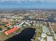Expansive aerial view of a waterfront community with canals, homes, and condo complexes under a partly cloudy sky at 1461 Aqui Esta Dr # B3, Punta Gorda, FL 33950